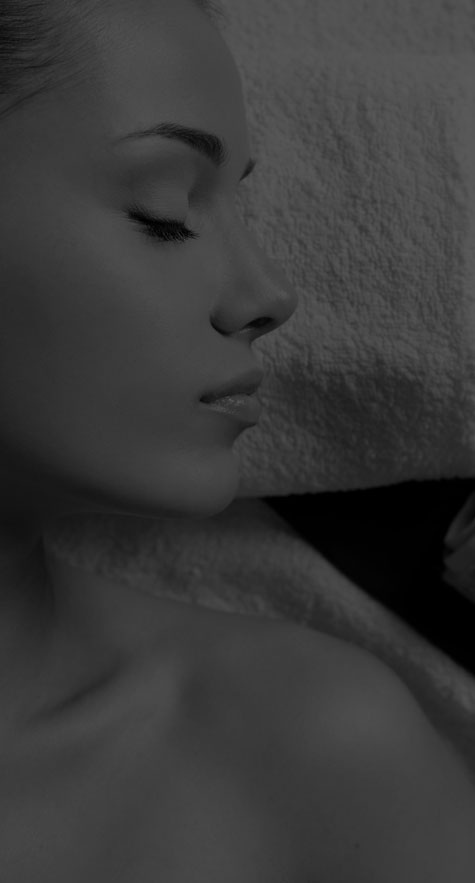 Woman relaxing at spa (grayscale)